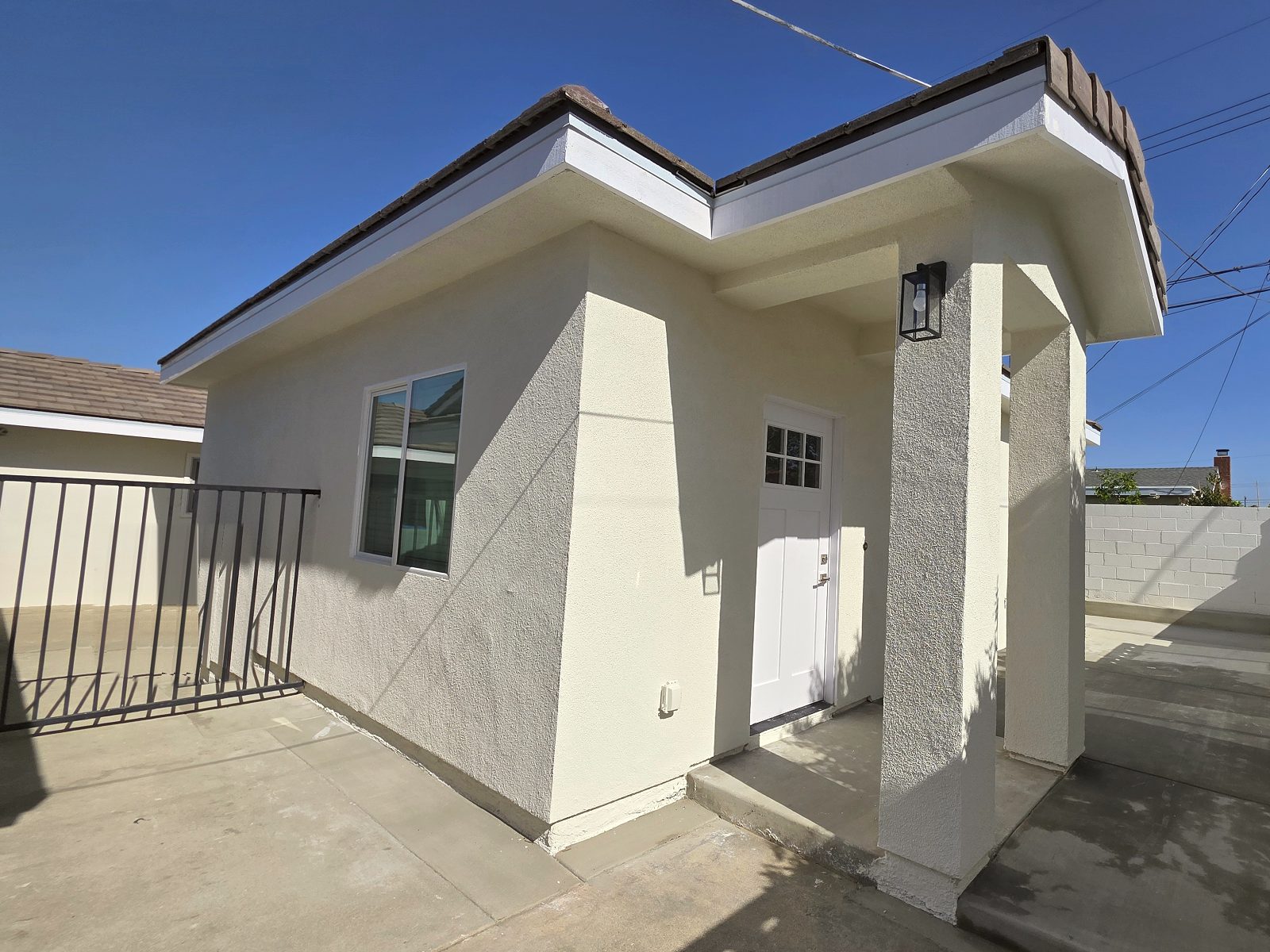 Exterior of a new detached ADU with a covered porch in Garden Grove