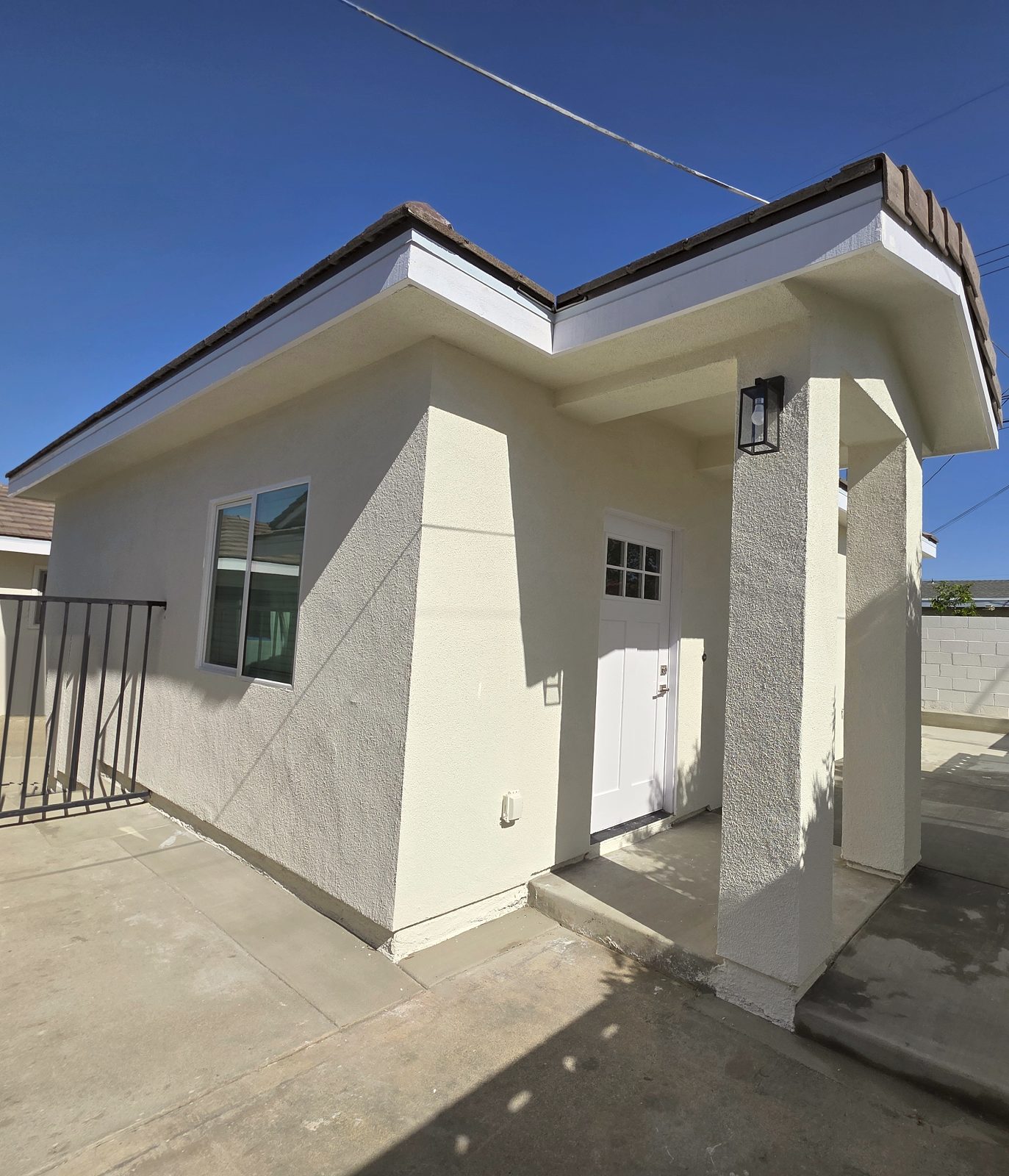 Exterior of a new detached ADU with a covered porch in Garden Grove