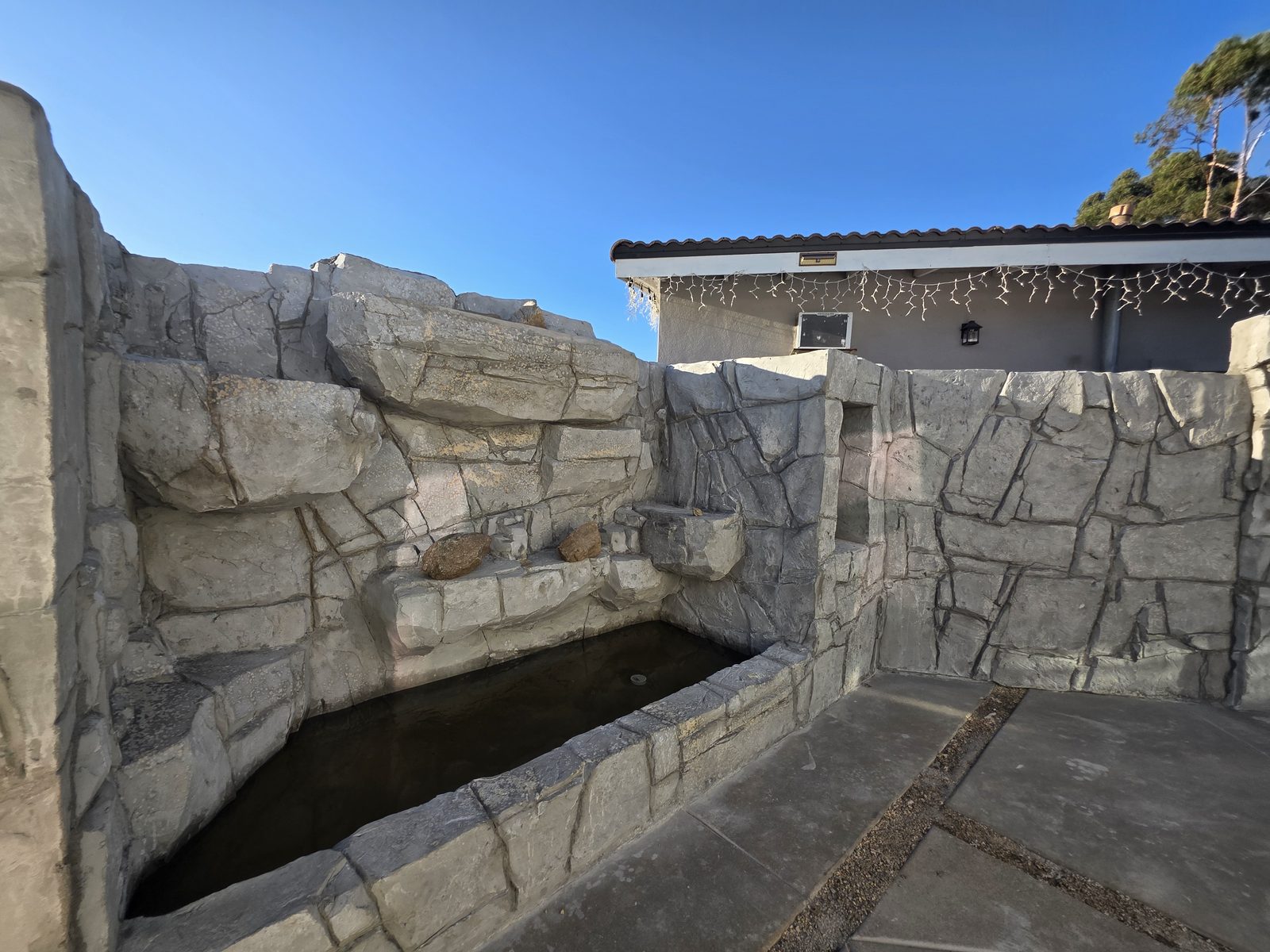 Stone-look hardscape wall with water feature