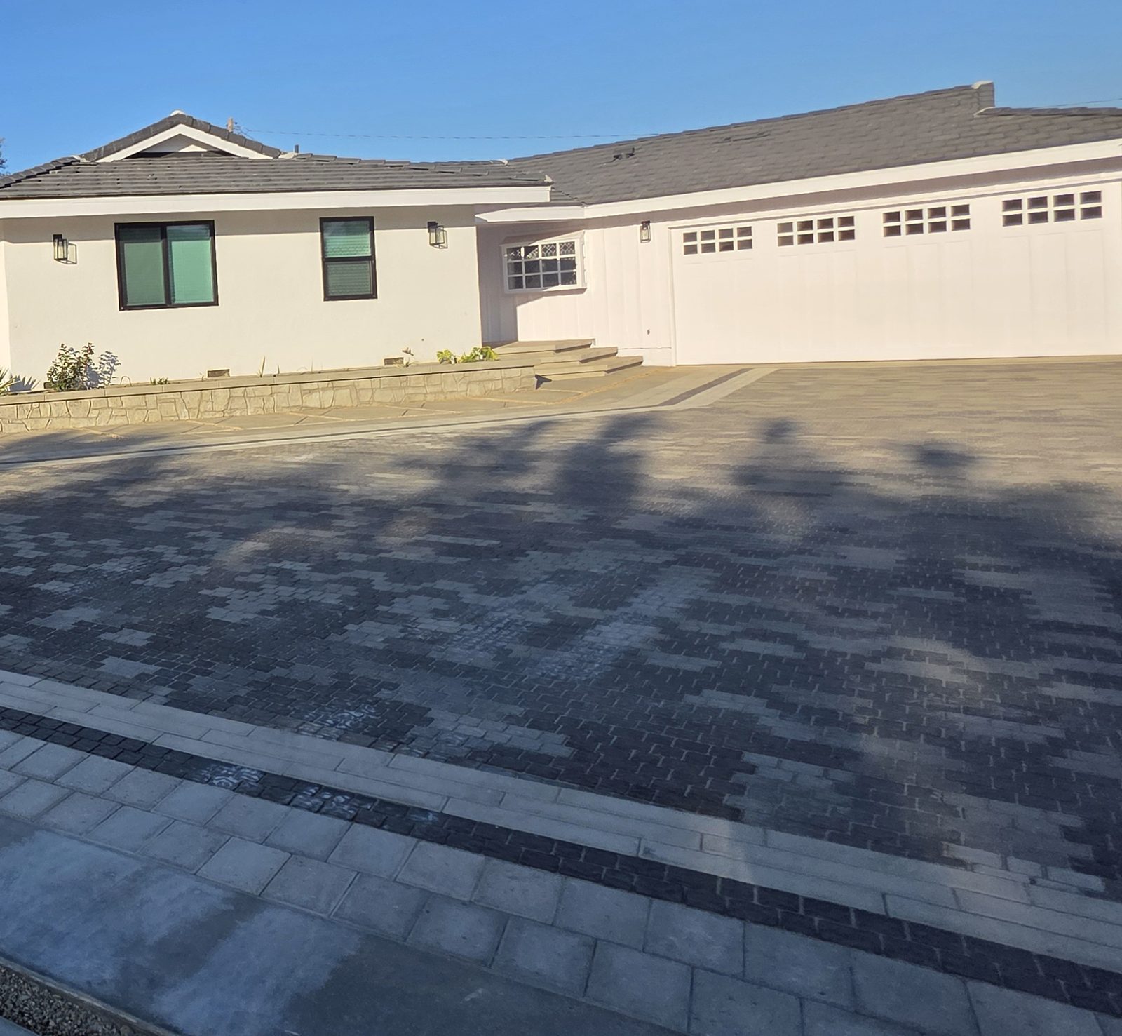 Remodeled front of the house with expanded paver driveway