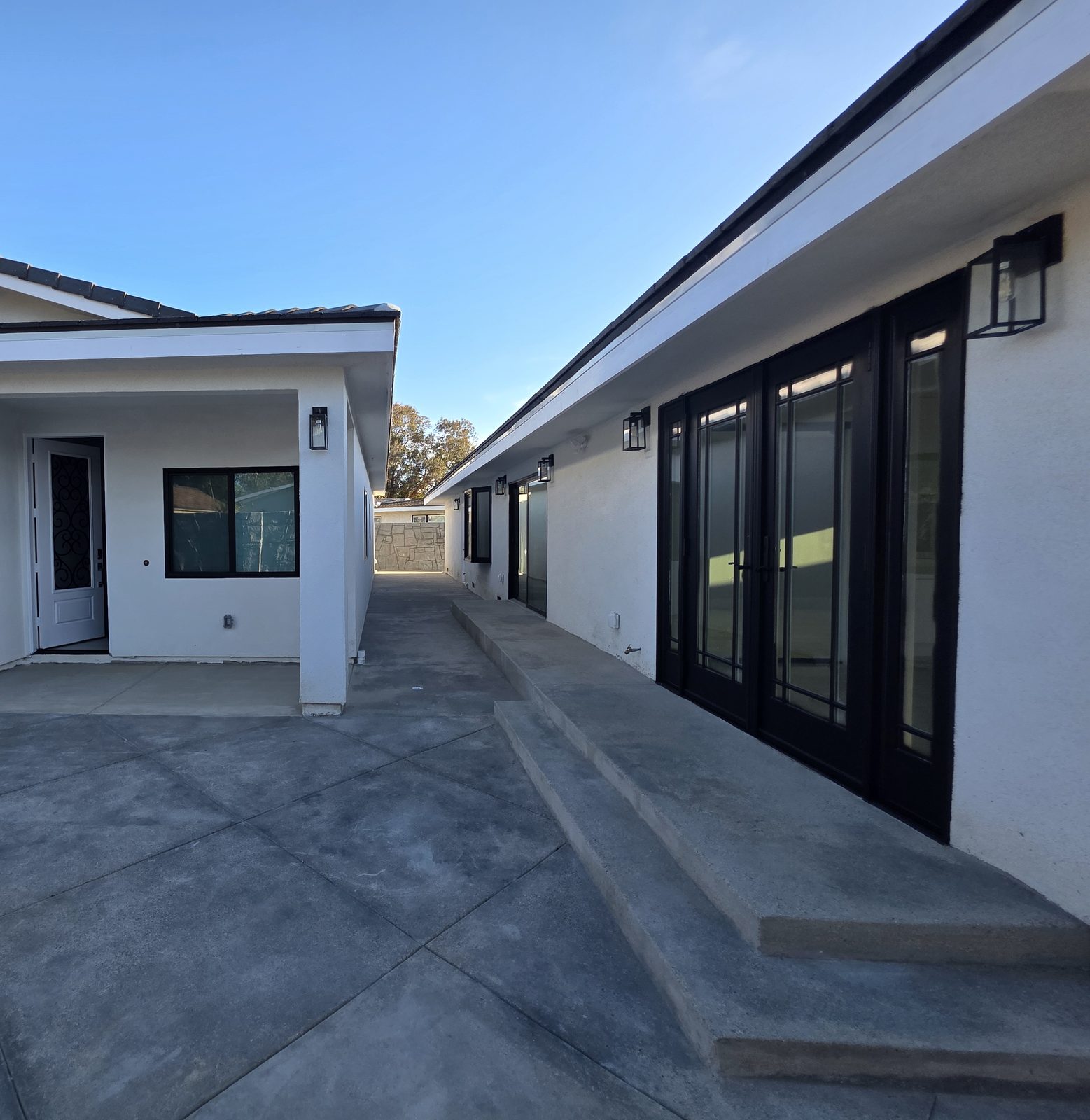 Courtyard between the ADU and the remodeled house in Garden Grove, with new French doors
