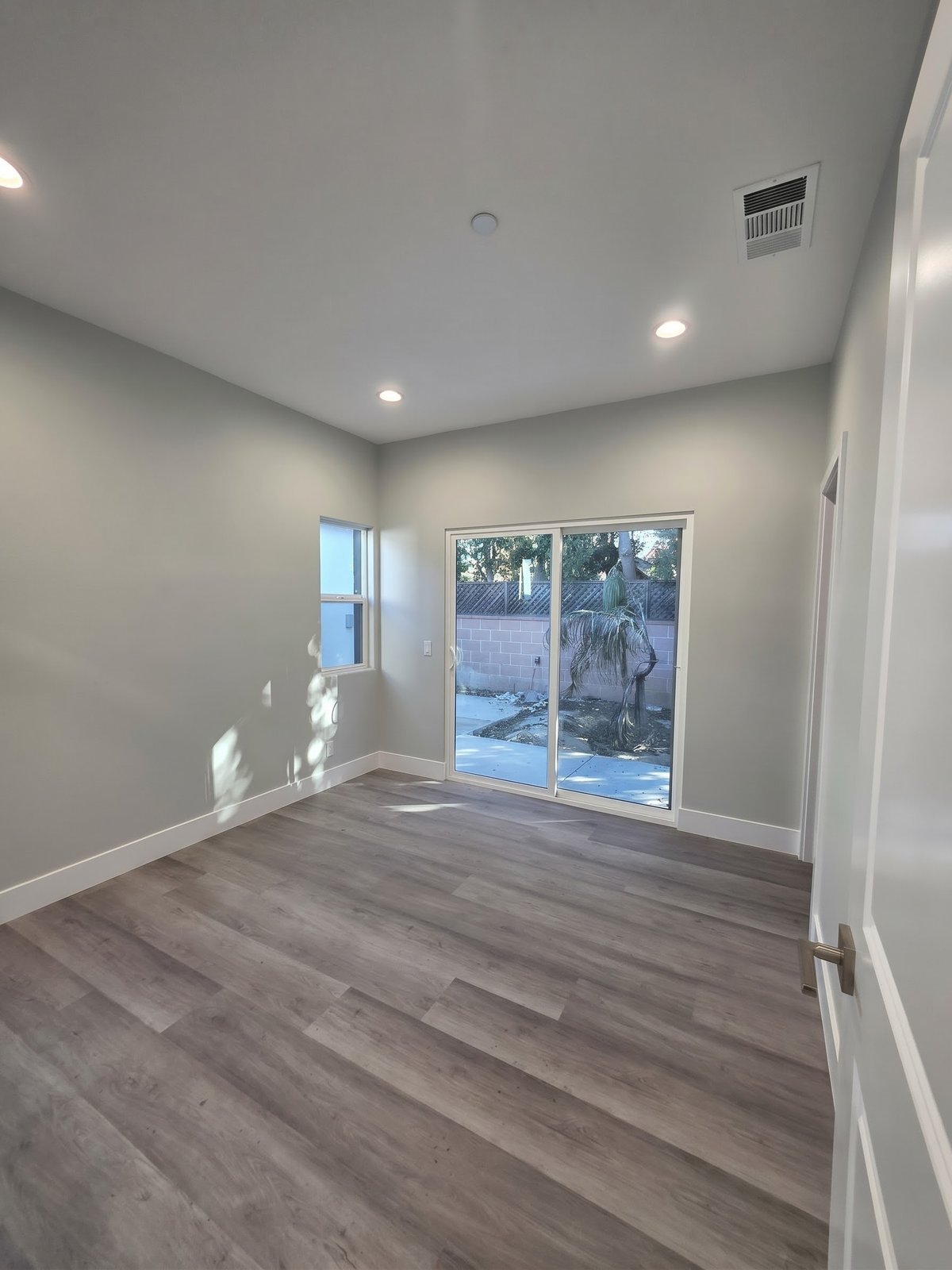 Bedroom with sliding glass door in a new SB9 home