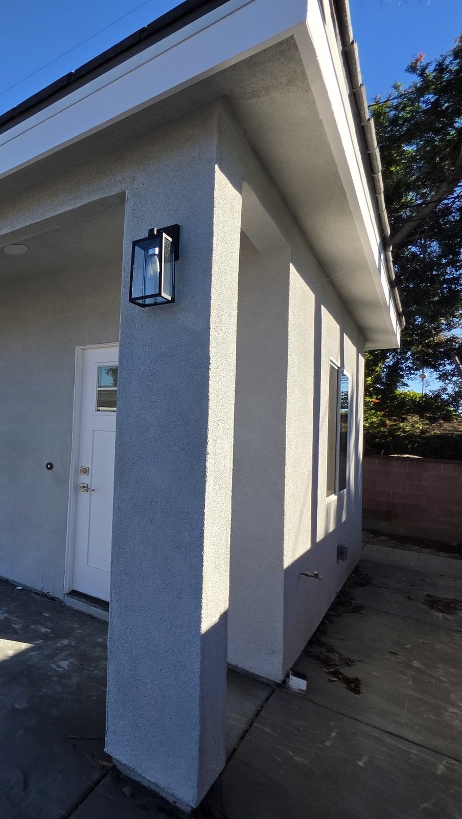 Covered front porch of a new single-story SB9 home in Garden Grove