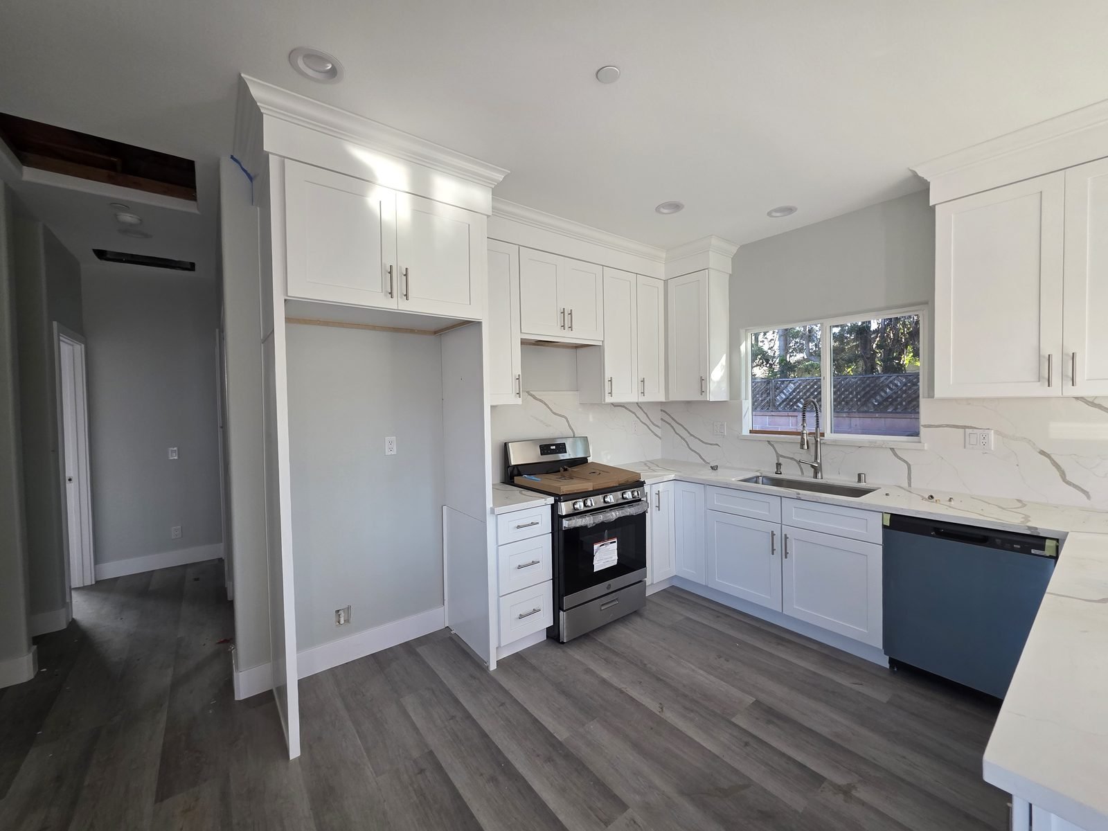 Kitchen with stainless range and dishwasher in a new SB9 home