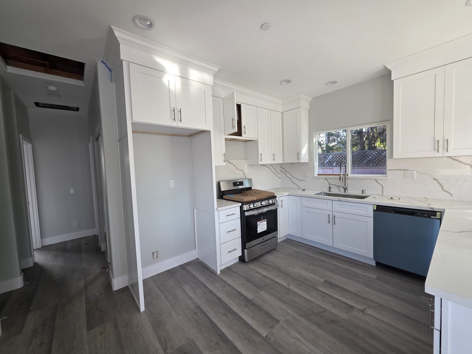 White shaker kitchen with quartz counters in a new SB9 home