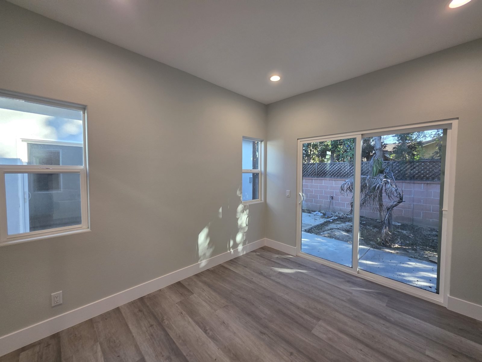 Bright living room with sliding glass door in a new SB9 home